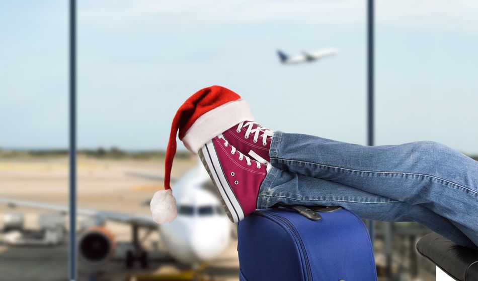 Traveler with Santa hat in airport