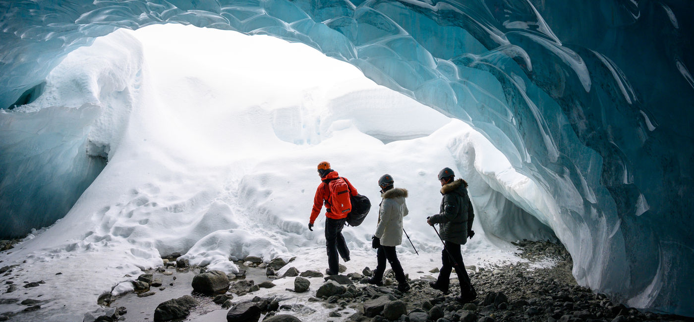 Image: Guided tour in a glacial ice cave (Photo Credit: Getty/stockstudioX)
