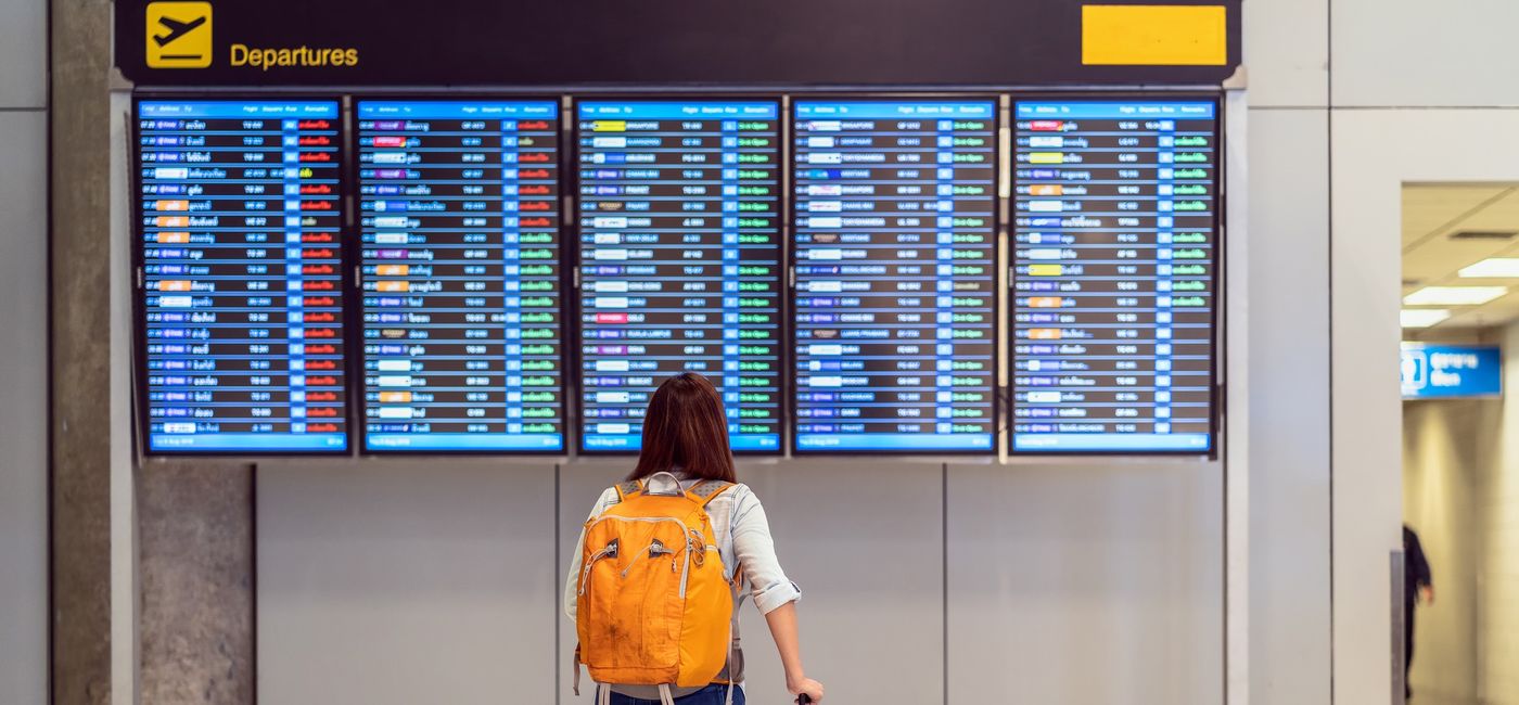 Image: Passenger checking the flight schedule. (photo via Tzido / iStock / Getty Images Plus)
