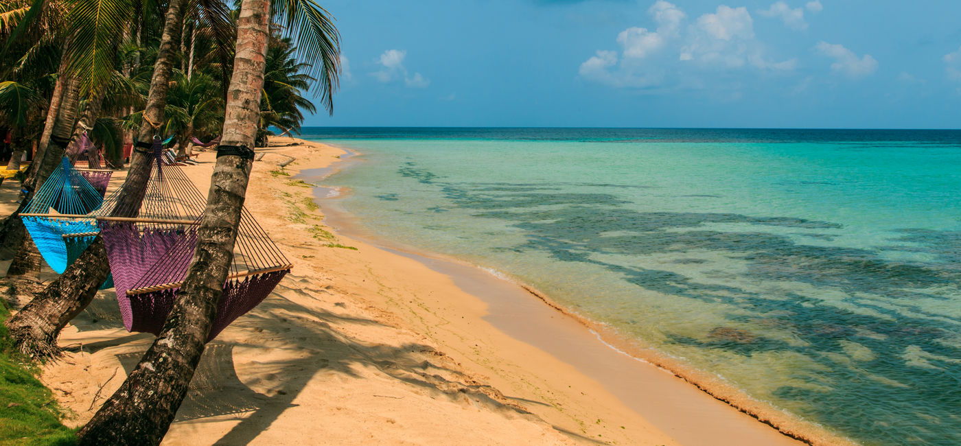 Image: tropical beach with hammock on palm, relax concept from Nicaragua (Photo via riderfoot / iStock / Getty Images Plus)