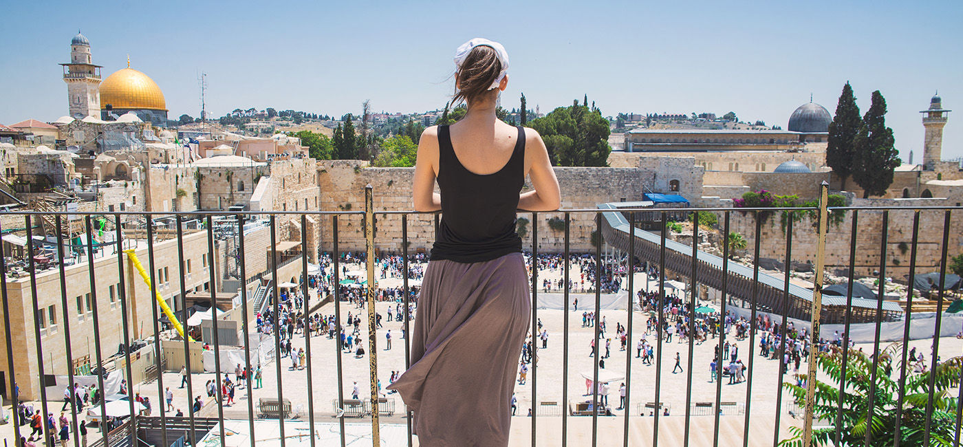 Image: Women looks on at Jerusalem old city, Israel (Photo Credit: Goway Travel/badahos/Adobe Stock)