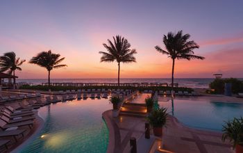 A colorful sky over a pool at Hilton Playa del Carmen