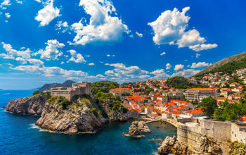 Croatia. South Dalmatia. General view of Dubrovnik - Fortresses Lovrijenac (left side) and Bokar seen from south old walls (it is on UNESCO World Heritage List since 1979) (photo via WitR / iStock / Getty Images Plus)